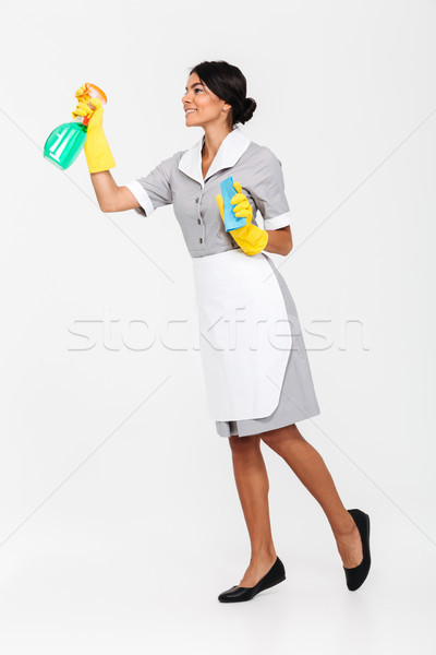 Full length photo of young brunette mais in uniform and yellow p Stock photo © deandrobot