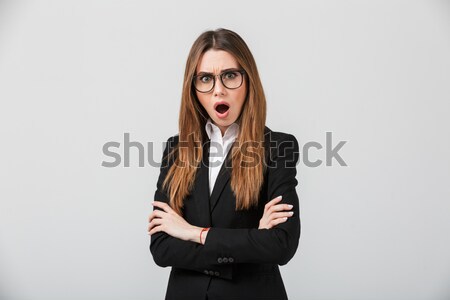 Portrait of an astonished businesswoman dressed in suit Stock photo © deandrobot
