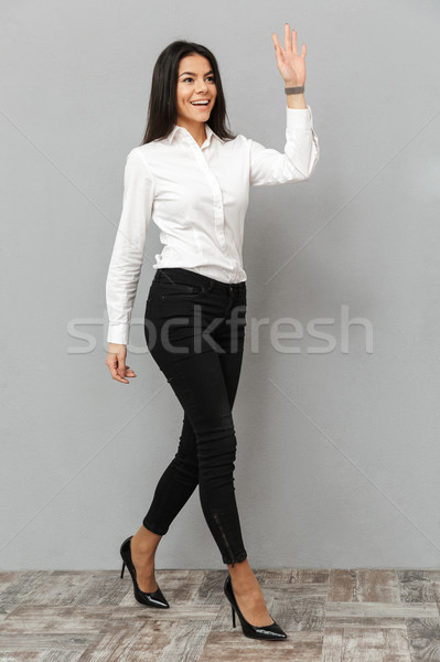 Full length image of happy businesswoman in white shirt and blac Stock photo © deandrobot