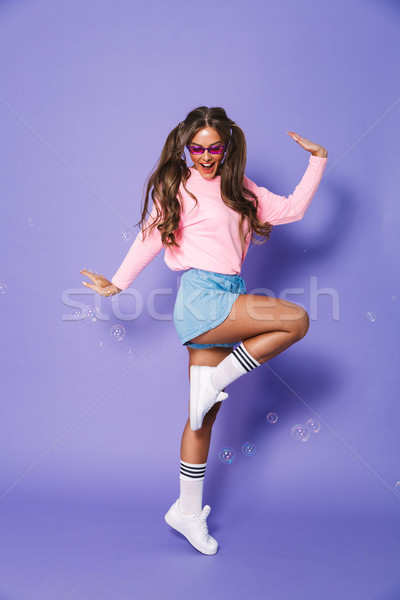 Full length portrait of astonished young girl with two ponytails Stock photo © deandrobot