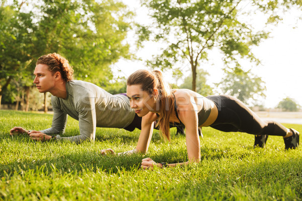 Photo of young caucasian sporty man and woman 20s in tracksuits, Stock photo © deandrobot