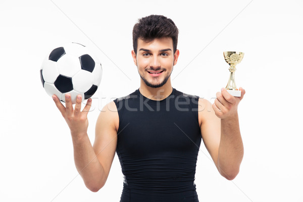 Football player holding winners cup Stock photo © deandrobot