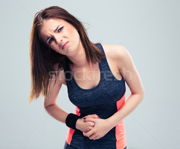 Mujer de la aptitud dolor estómago gris cuerpo fitness Foto stock © deandrobot