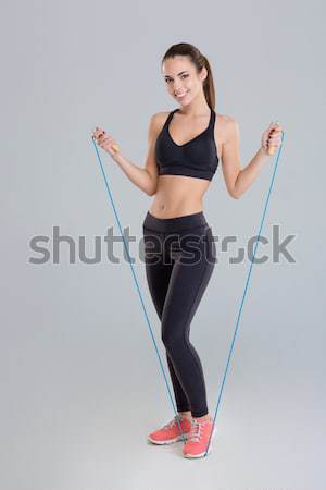Sportos nő mutat nagy nadrág derűs Stock fotó © deandrobot