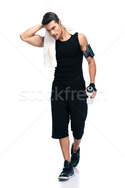 Fitness man holding towel and bottle with water Stock photo © deandrobot