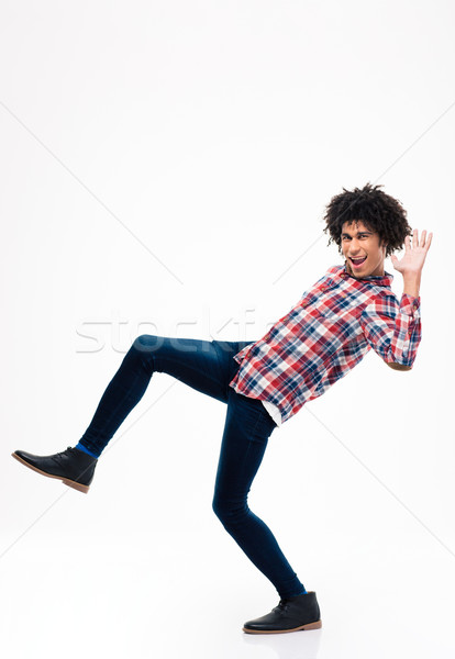Full length portrait of afro american man falling Stock photo © deandrobot
