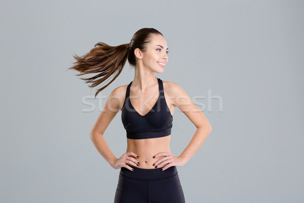 Positive cheerful fitness woman warming up and turning her head  Stock photo © deandrobot