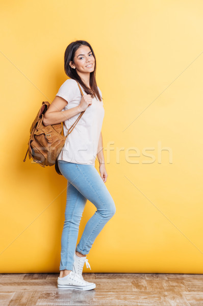 Full length portrait of a smiling woman with backpack Stock photo © deandrobot