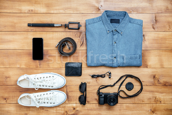 Travel concept shoes, shirt, mobile phone, eyeglasses, belt, lig Stock photo © deandrobot