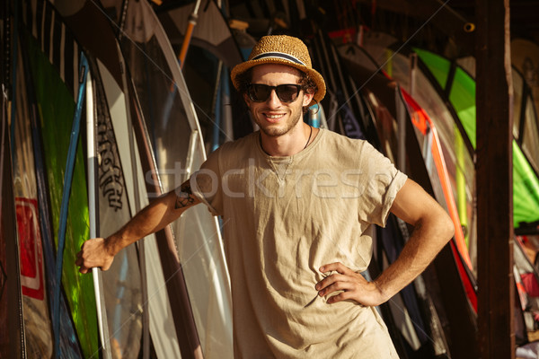 Man in hat and sunglasses standing at the surf shack Stock photo © deandrobot