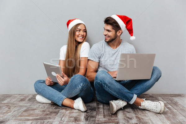 Christmas photo of couple with laptops Stock photo © deandrobot
