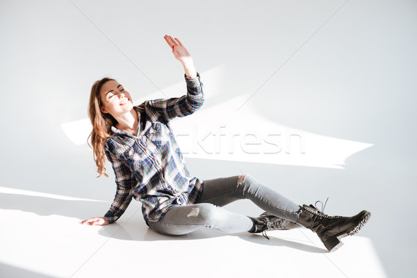 Lady lies on floor at studio while covering eyes Stock photo © deandrobot