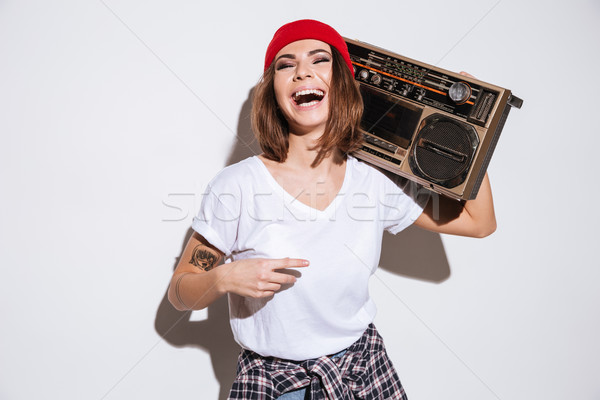 Young pretty lady holding tape recorder. Stock photo © deandrobot