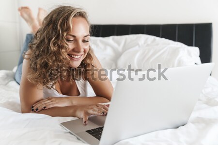 Cheerful pregnant young woman using blank screen tablet on sofa Stock photo © deandrobot