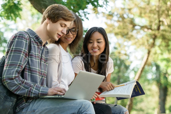 Multiethnic group of young concentrated students Stock photo © deandrobot