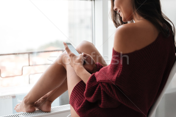 Cropped image of a smiling young woman Stock photo © deandrobot