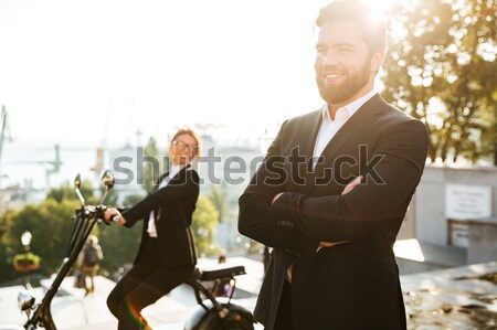 Despreocupado homem de negócios posando ao ar livre mulher Foto stock © deandrobot