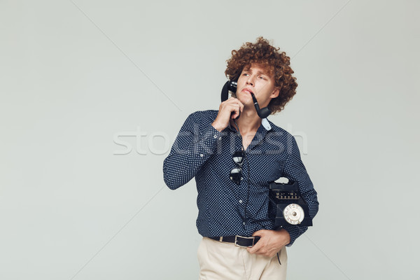 Handsome retro man with telephone in hands. Stock photo © deandrobot