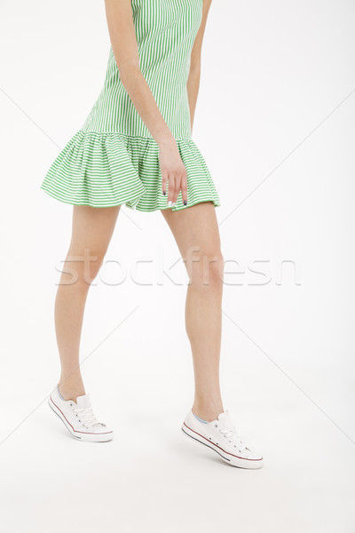 Half body portrait of a young girl in dress walking Stock photo © deandrobot