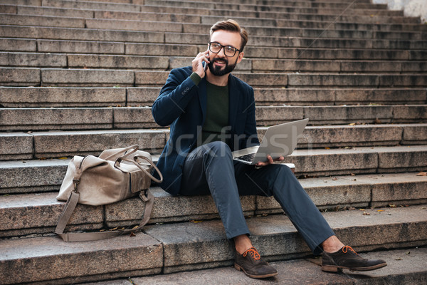 Portrait heureux homme lunettes travail portable [[stock_photo]] © deandrobot