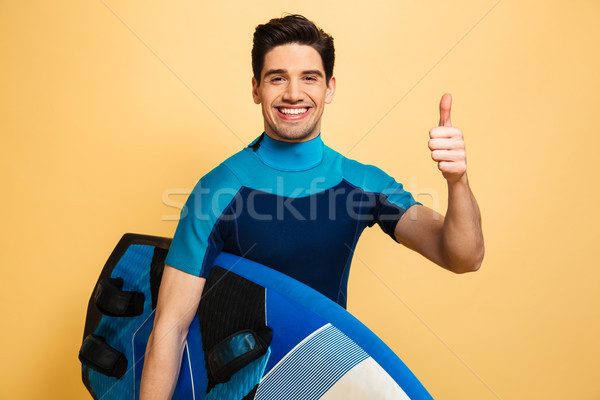 Portrait of a smiling young man dressed in swimsuit Stock photo © deandrobot