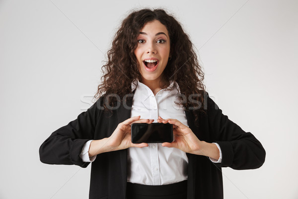 Portrait of an excited young businesswoman Stock photo © deandrobot