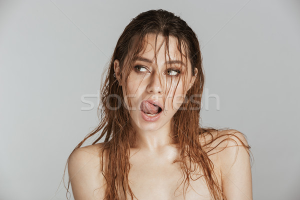 Amazing young beautiful woman with wet hair licking her lips. Stock photo © deandrobot