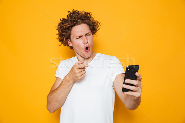 Resented outraged man in casual white t-shirt arguing and pointi Stock photo © deandrobot