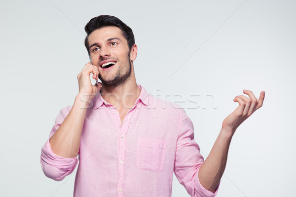 Happy businessman talking on the phone Stock photo © deandrobot