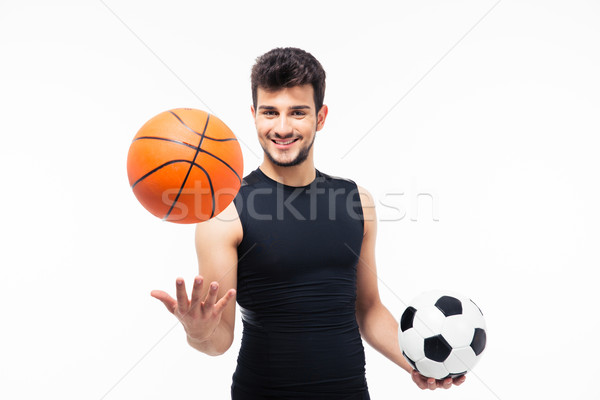 Sports man holding basketball and soccer ball Stock photo © deandrobot