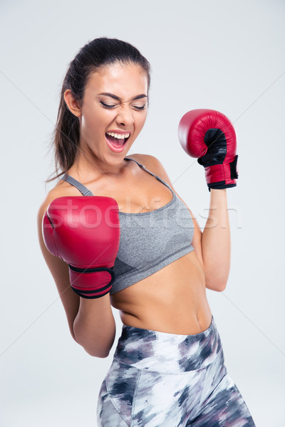 Sports woman with boxing gloves celebrating her victory Stock photo © deandrobot