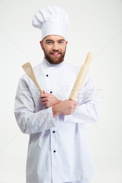 Stock photo: Male chef cook holding a rolling pin and spoon
