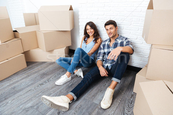 Happy young couple moving in new house Stock photo © deandrobot