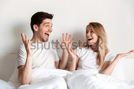 Two angry women in white shirt fighting in bed Stock photo © deandrobot