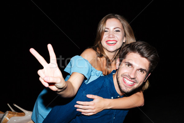 Cheerful young couple showing peace sign and having fun Stock photo © deandrobot