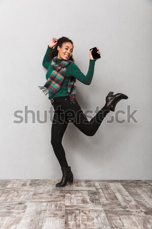 Hipster in red shirt jumping Stock photo © deandrobot