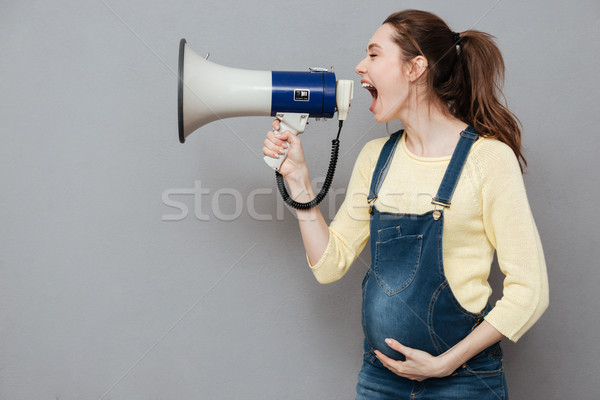 Pregnant screaming woman holding loudspeaker Stock photo © deandrobot
