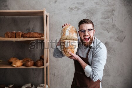 Screaming man baker standing with paper bag on head Stock photo © deandrobot