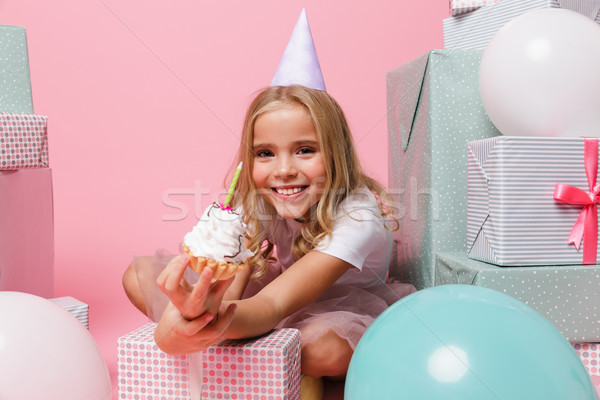 Portrait of a little girl in a birthday hat celebrating Stock photo © deandrobot