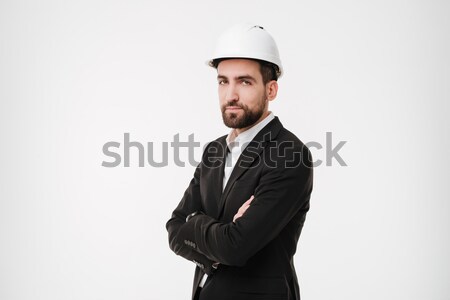 Cool bearded business man in protective helmet holding crossed arms Stock photo © deandrobot