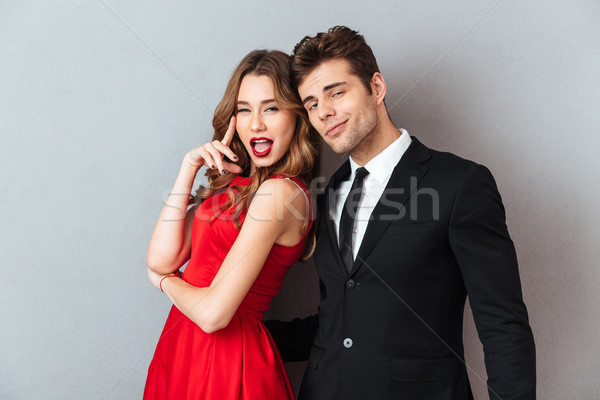 Portrait of a beautiful young couple dressed in formal wear Stock photo © deandrobot