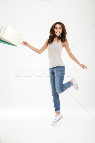 Full-length picture of delighted adult girl levitating or jumpin Stock photo © deandrobot