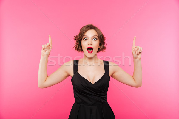 Stock photo: Portrait of an excited girl dressed in black dress