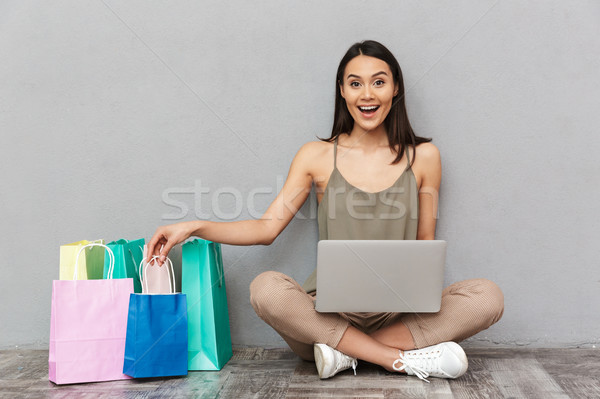 Full length portrait of a satisfied young asian woman Stock photo © deandrobot