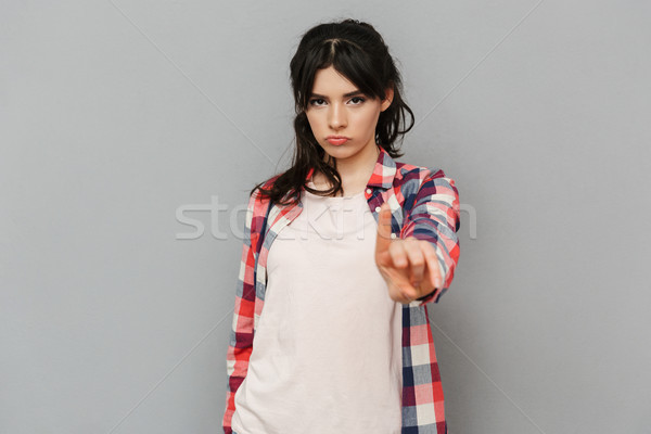 Displeased sad young lady make stop gesture. Stock photo © deandrobot
