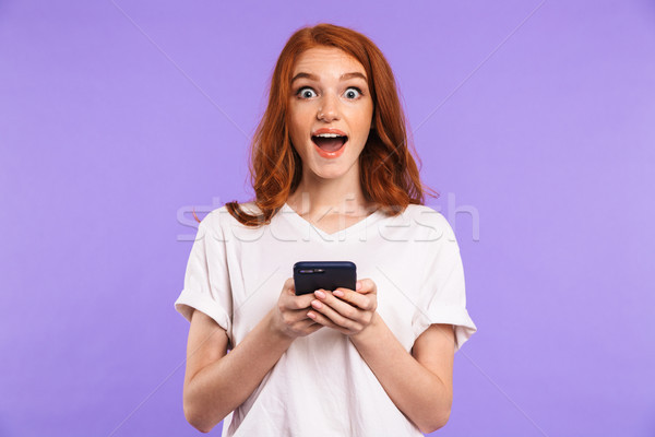 Portrait of an excited young girl standing Stock photo © deandrobot