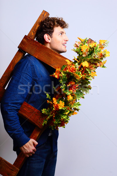 Portrait of a funny man holding stepladder Stock photo © deandrobot