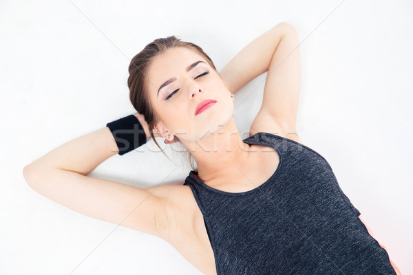 Sporty woman sleeping on the floor Stock photo © deandrobot