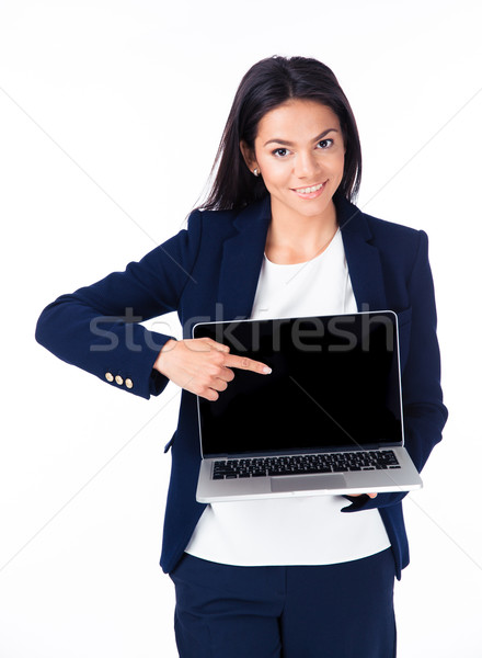 Smiling businesswoman pointing on the blank laptop screen Stock photo © deandrobot