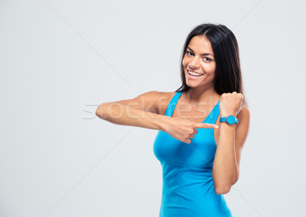 Happy fitness woman pointing on fitness tracker Stock photo © deandrobot